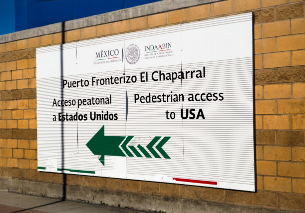 Sign posted at “El Chaparral,” the port of entry where asylum-seekers line up to collect a nu...